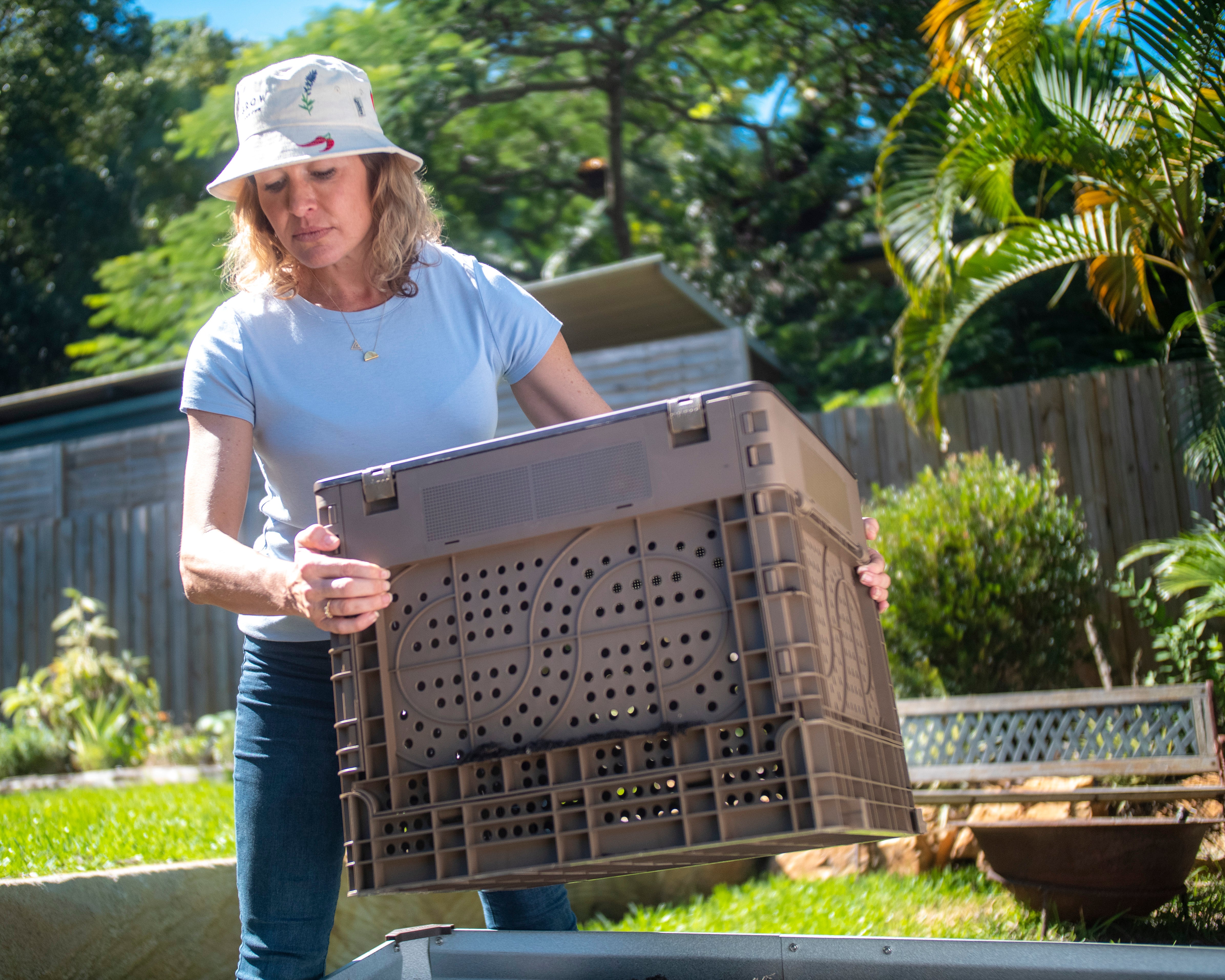 woman setting up subpod in garden compost bin